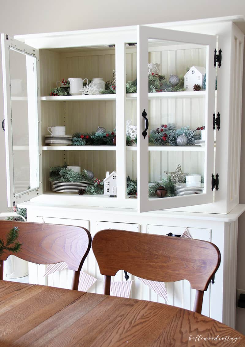 A farmhouse hutch is a beautiful centerpiece for any room. Learn how to style and decorate your hutch for Christmas with these budget-friendly tips! | Bellewood Cottage |