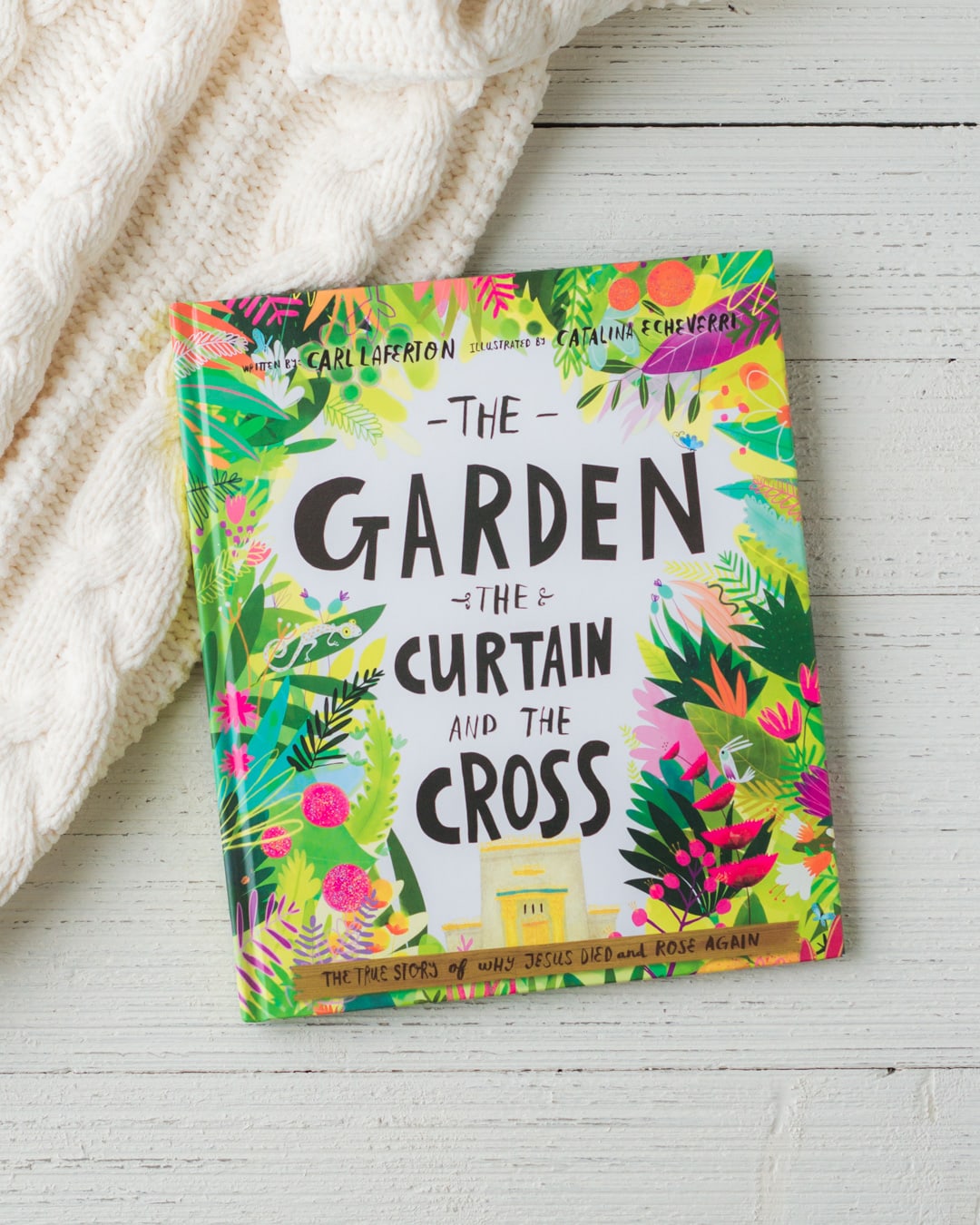 The Garden, the Curtain, and the Cross book on a wooden background.