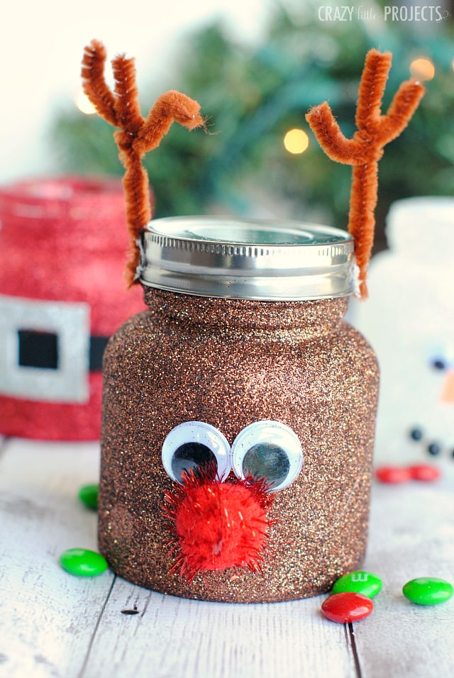 A mason jar decorated as a reindeer with glitter.