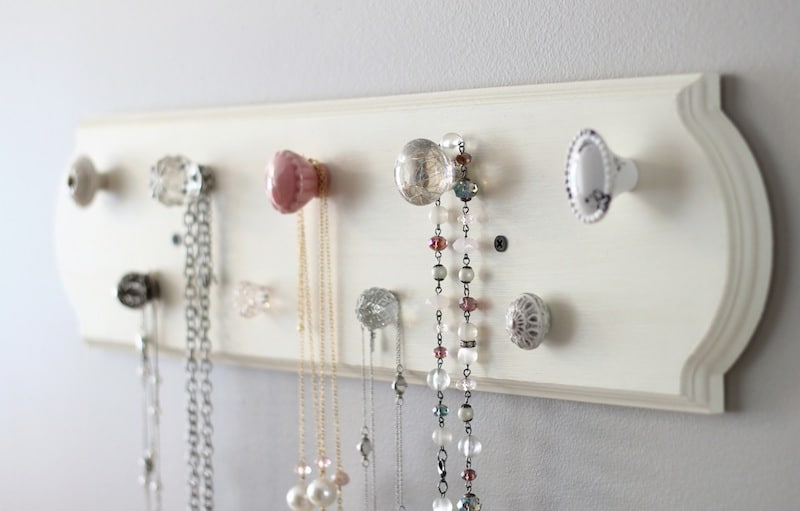 A necklace organizer made with knobs from Hobby Lobby.