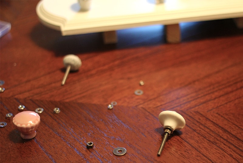 Washers and a variety of knobs on a wooden surface.