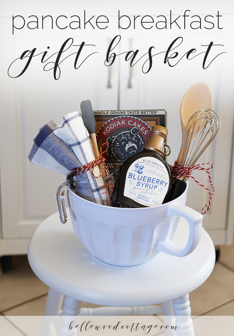 A bridal shower gift basket filled with pancake mix, syrup, and supplies to make pancakes.