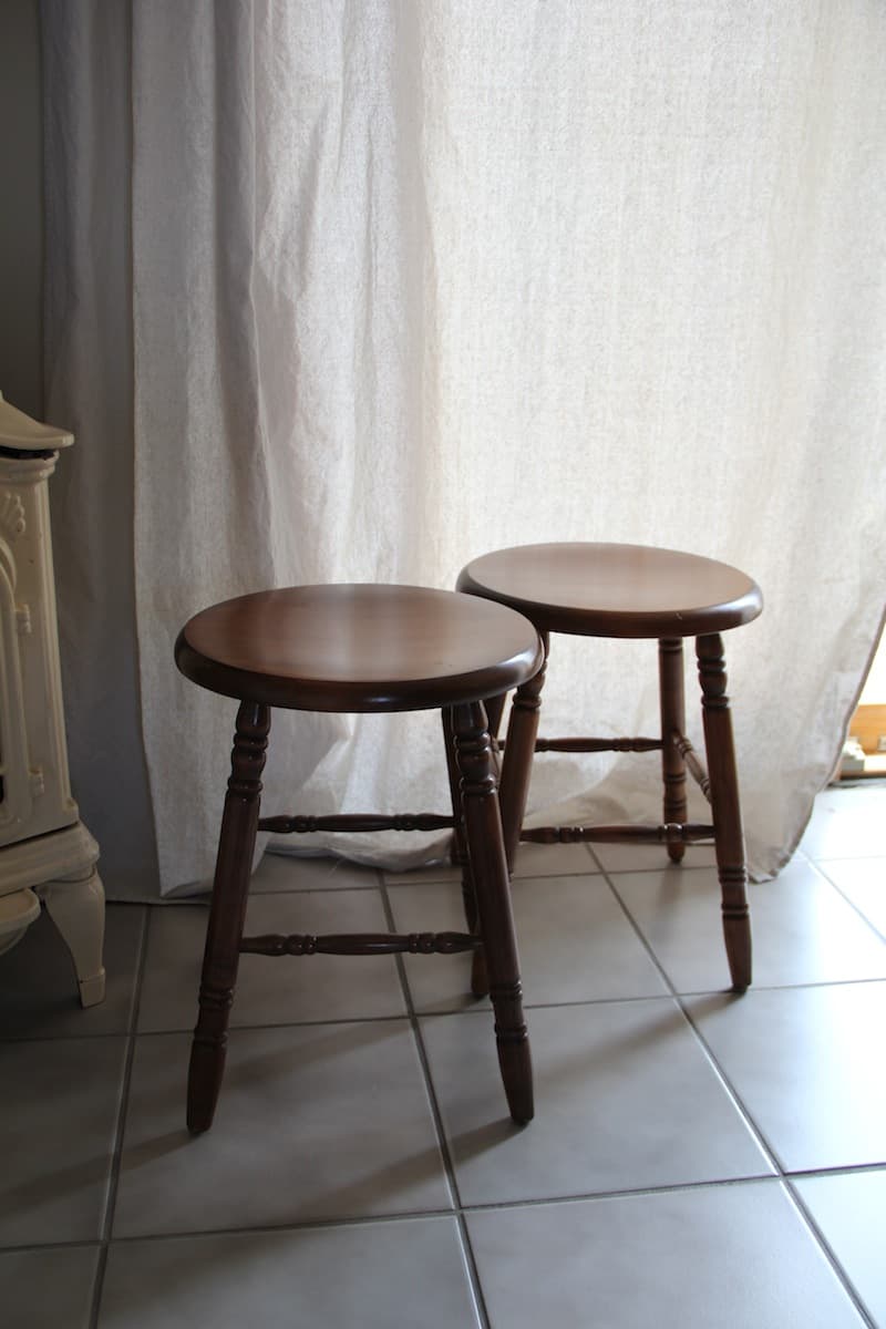 Two old dark wooden stools.