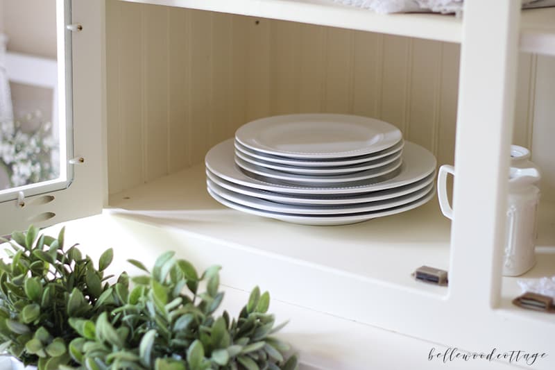 how to style a hutch - classic white dishes and greenery