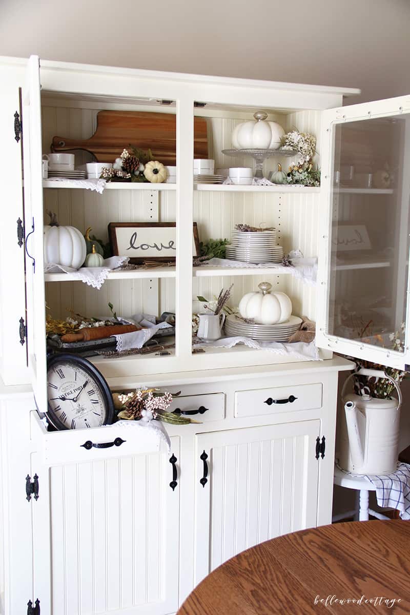 Learn how to maximize your decorating budget and use the decor you already own to style a beautiful fall farmhouse hutch!