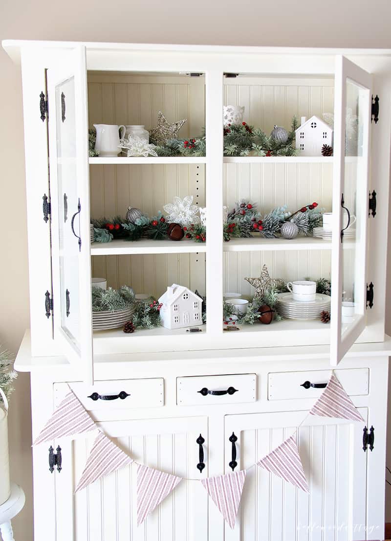 A farmhouse hutch is a beautiful centerpiece for any room. Learn how to style and decorate your hutch for Christmas with these budget-friendly tips! | Bellewood Cottage |