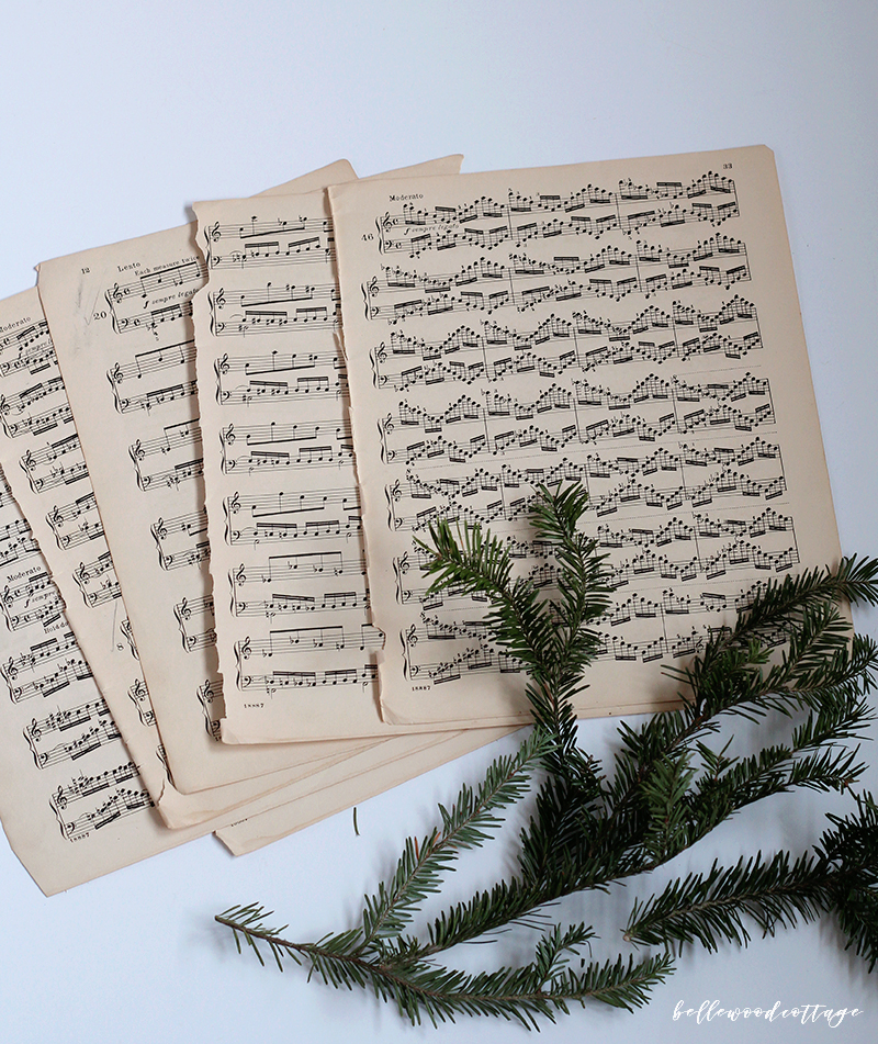 Get inspired to create pretty DIY Christmas decorations with this easy idea for incorporating sheet music decor and fresh pine into your homemade Christmas!