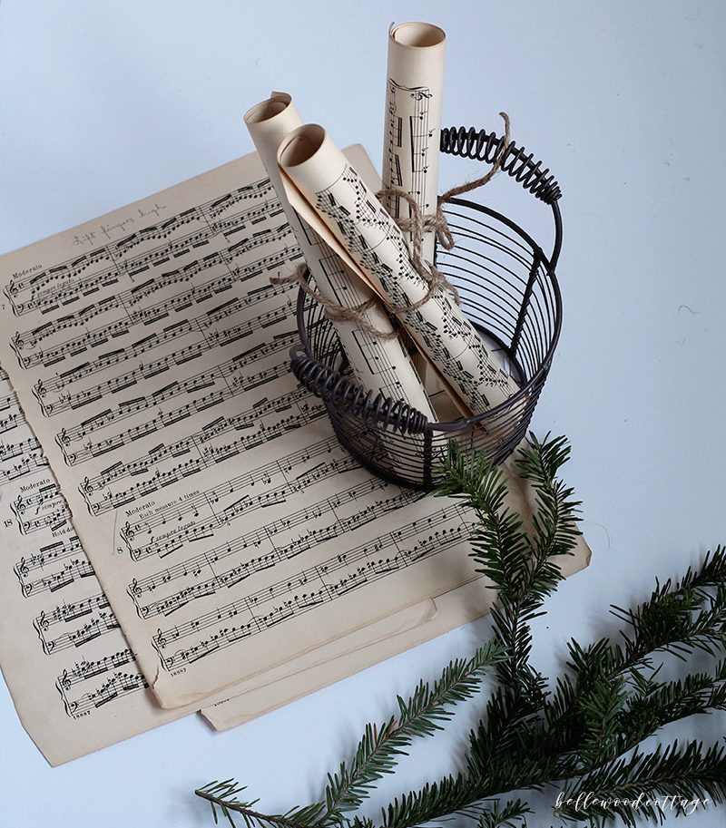 Get inspired to create pretty DIY Christmas decorations with this easy idea for incorporating sheet music decor and fresh pine into your homemade Christmas!