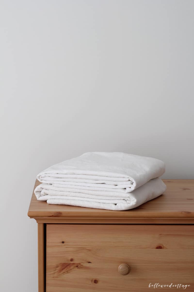 Two bleached drop cloths on a pine dresser.