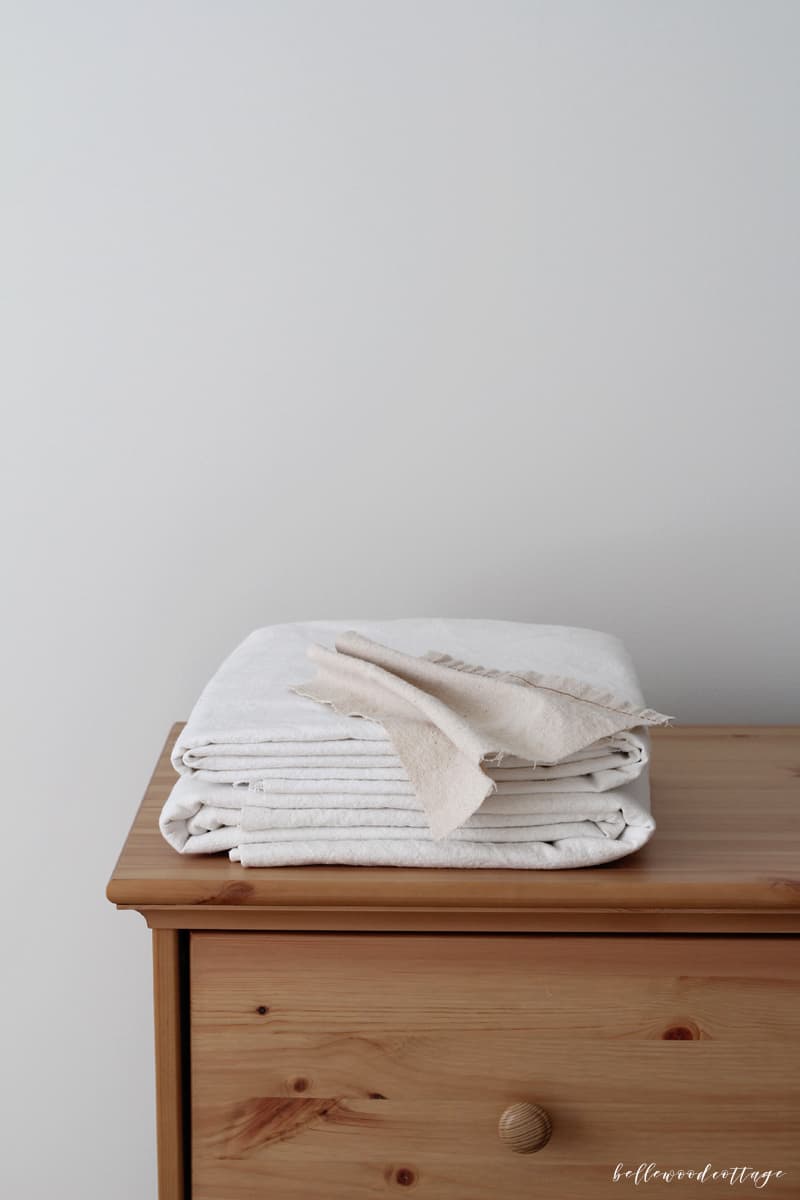 Bleached drop cloths on a pine dresser.