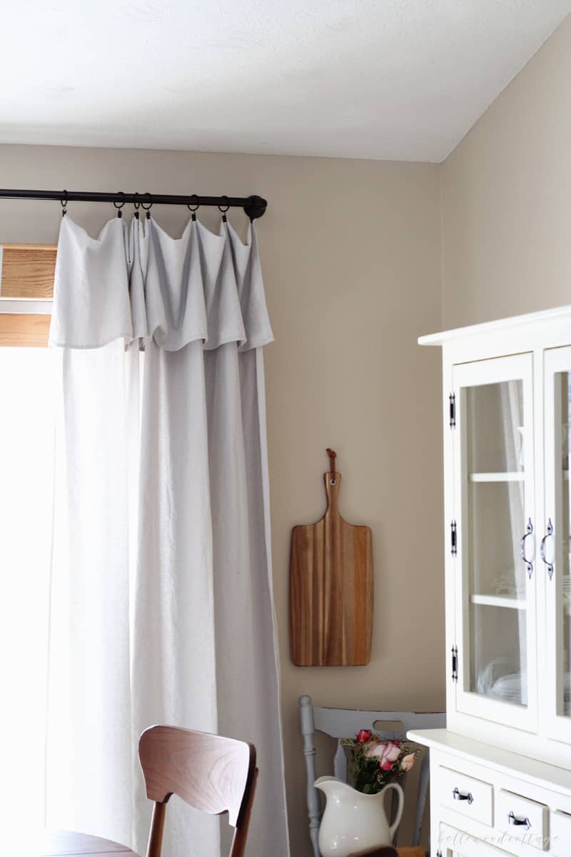 Unbleached drop cloth curtains hanging in a dining room.