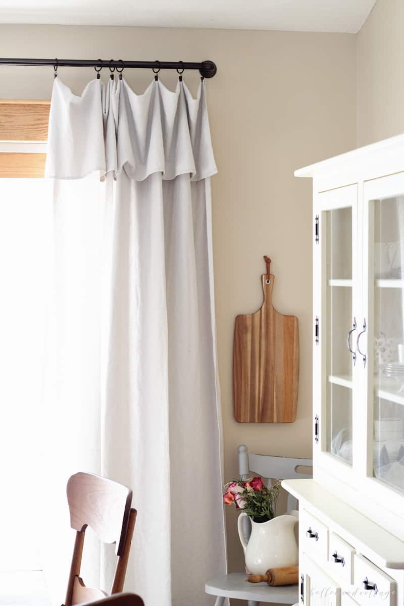 Unbleached drop cloth curtains hanging in a dining room.