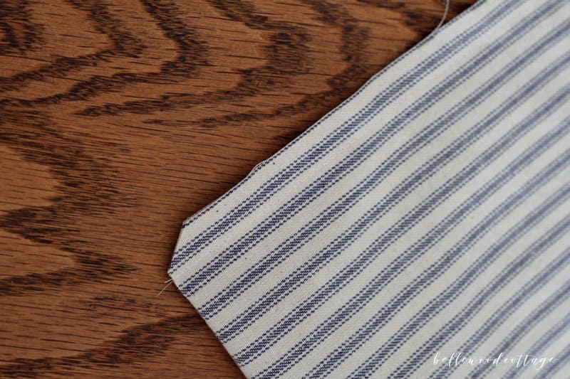 Learn how you can sew farmhouse style pillows with my ticking stripe pillow cover tutorial. This tutorial covers all the steps needed to make these quick and easy-to-sew pillow covers. You'll love the way that ticking stripes give your home an authentic farmhouse vibe!