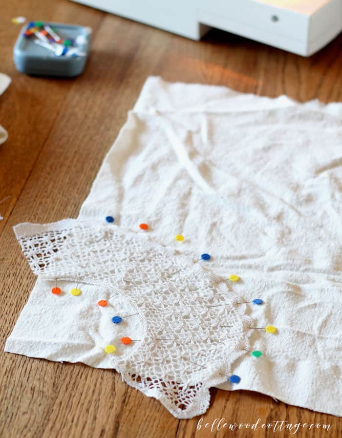 Learn how to make DIY drop cloth pillows using bleached drop cloths, antique lace, and a fun tecnhique that will make one pillow cover look like two!