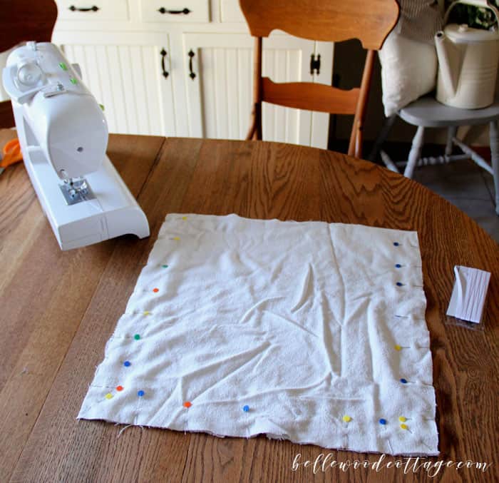 Learn how to make DIY drop cloth pillows using bleached drop cloths, antique lace, and a fun tecnhique that will make one pillow cover look like two!