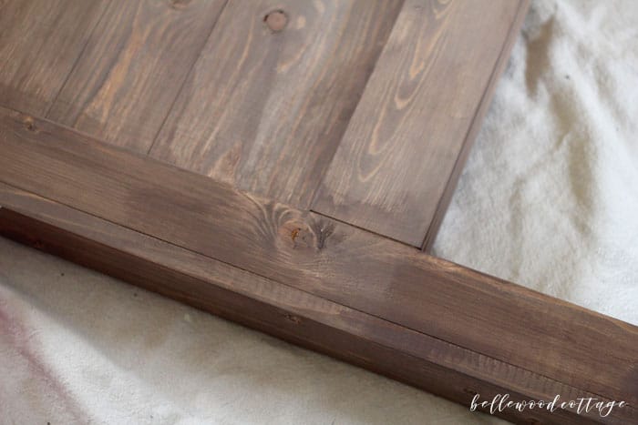 Learn my technique for how to use milk paint as a stain, as seen on my DIY Farmhouse Headboard. An easy (and non-toxic!) way to stain wood! #BellewoodCottage #diytutorial #milkpaint #mmsmp #nontoxicpaint