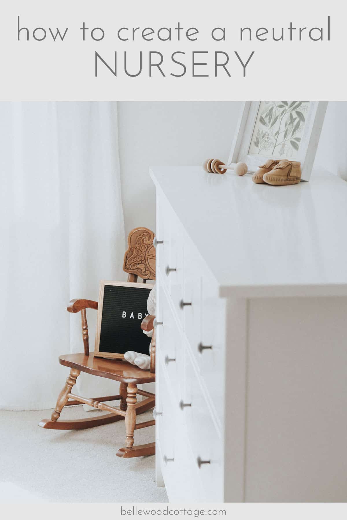 Rocking chair with a letter board with the word "baby" on it in a neutral nursery.