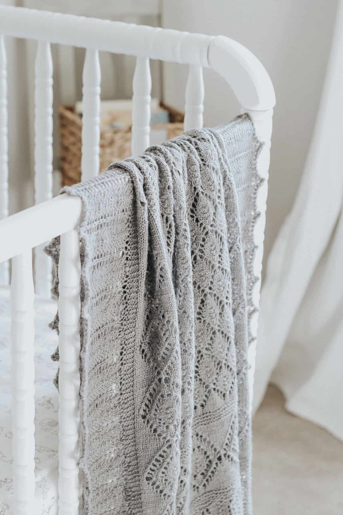 Close up view of heirloom knit blanket on a Jenny Lind crib.