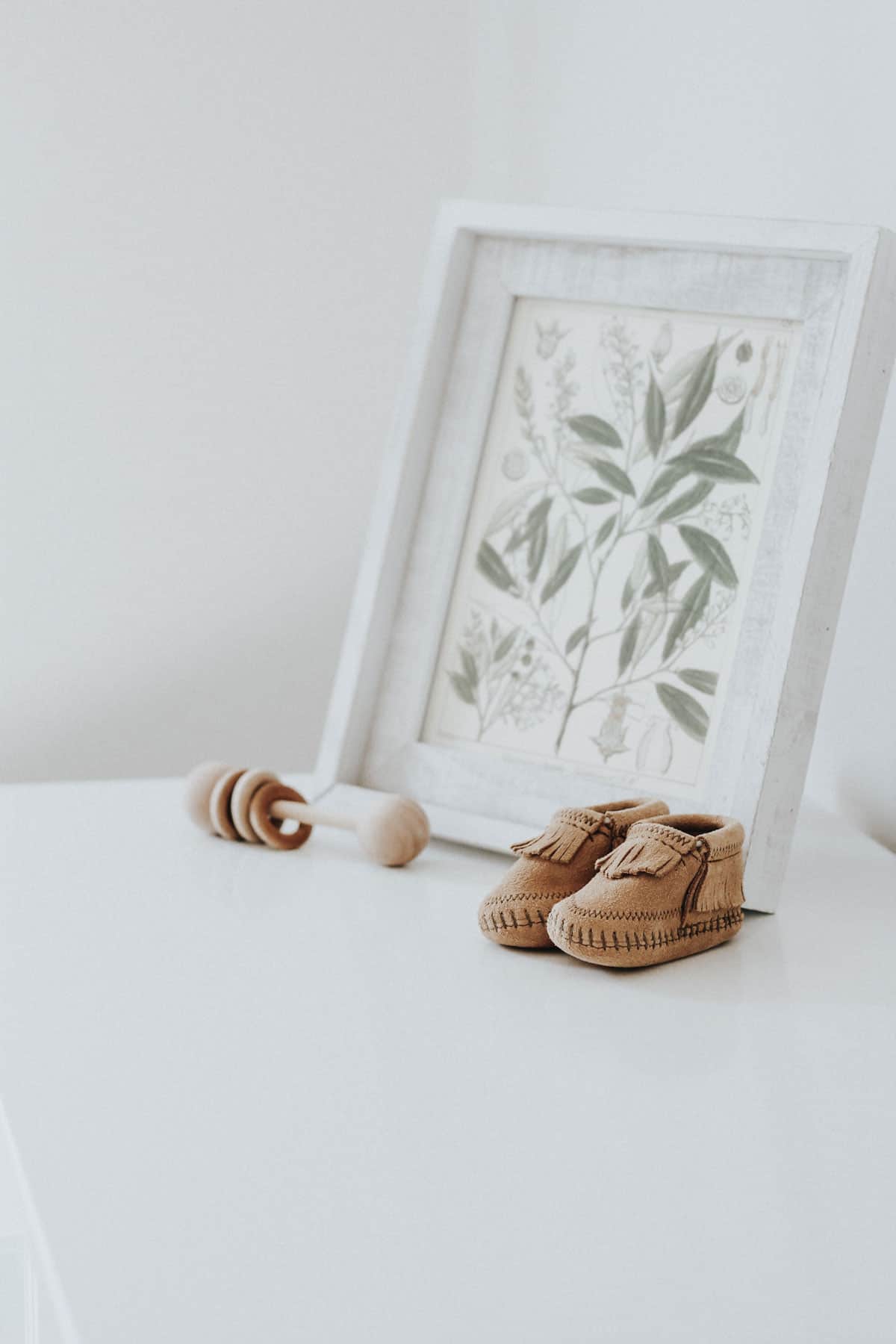 Moccasins and a wooden baby rattle.