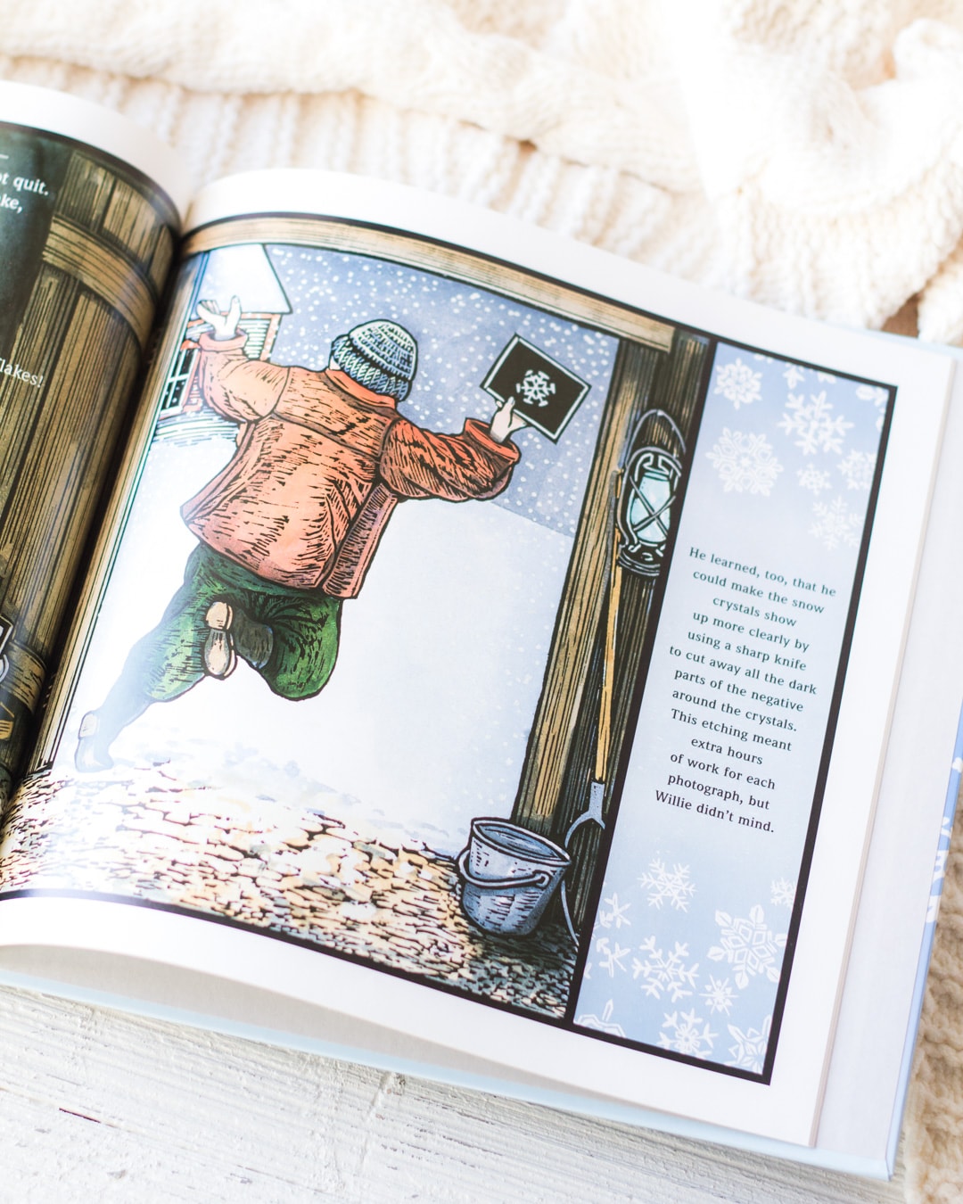 An illustration of Wilson Bentley with his snowflake photograph from the picture book, Snowflake Bentley.