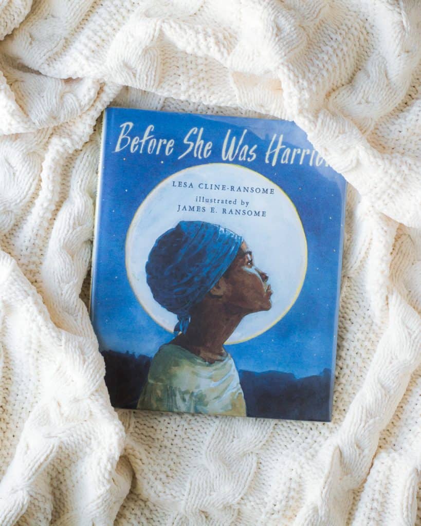 Before She Was Harriet picture book on a white knit blanket.