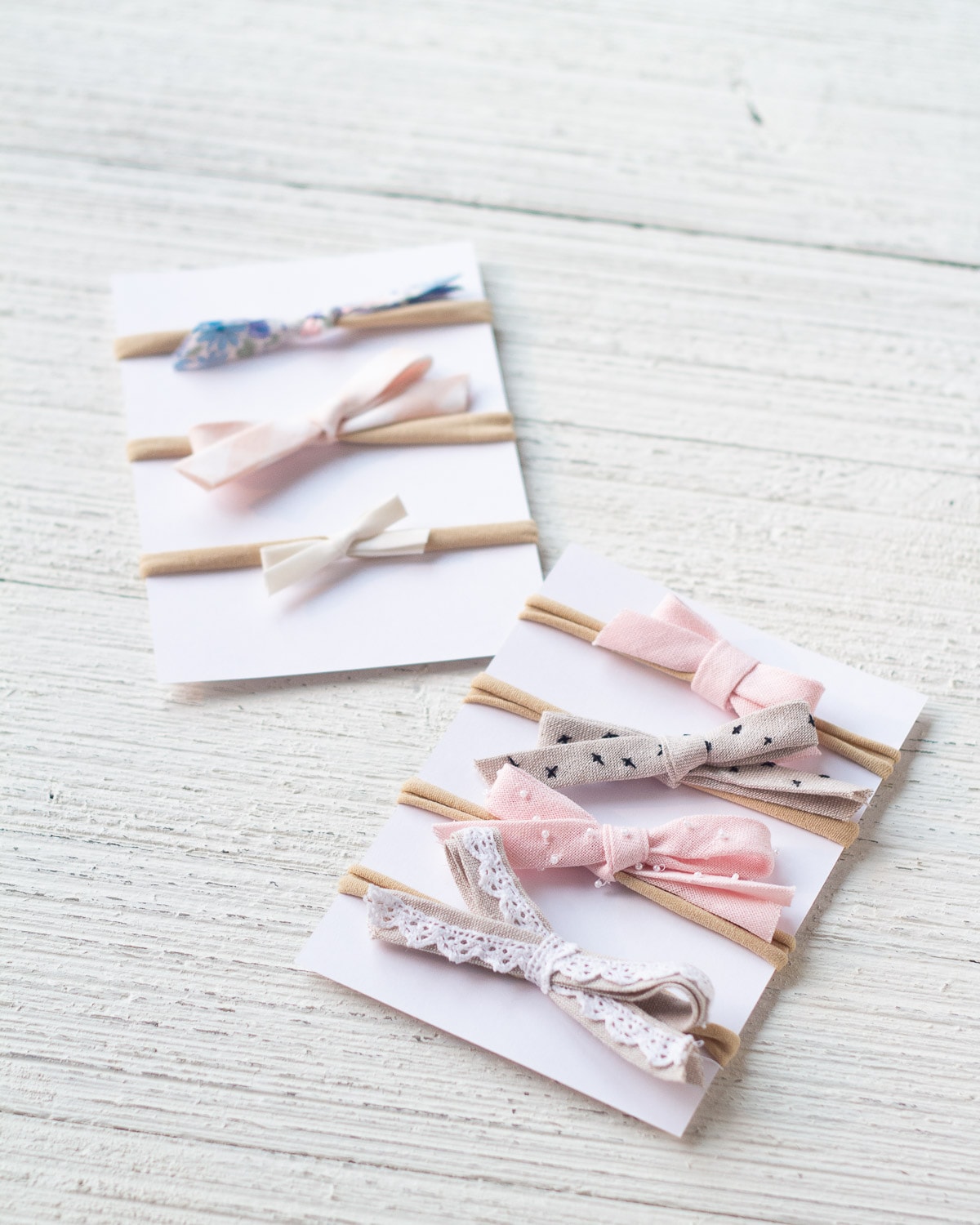 Seven styles of bias tape hair bows arranged on display cards.