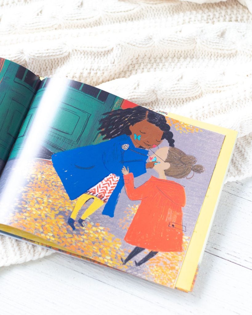 The inside pages of a picture book showing two young girls exchanging sparkly butterfly stickers.