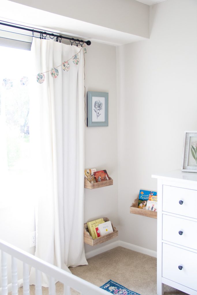 A DIY Paper Garland hanging on a curtain rod.