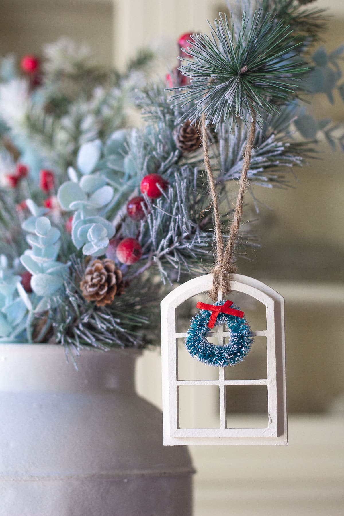 A Christmas ornament hanging from a pine bough.