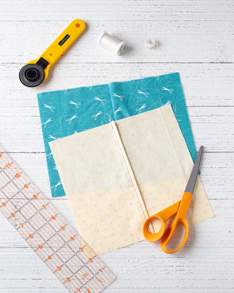 French seams on fabric samples and sewing supplies on a wooden background.