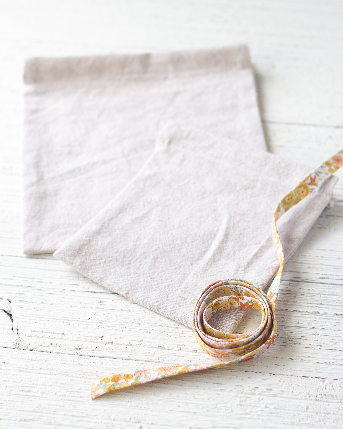 A roll of bias tape and linen drawstring bags.