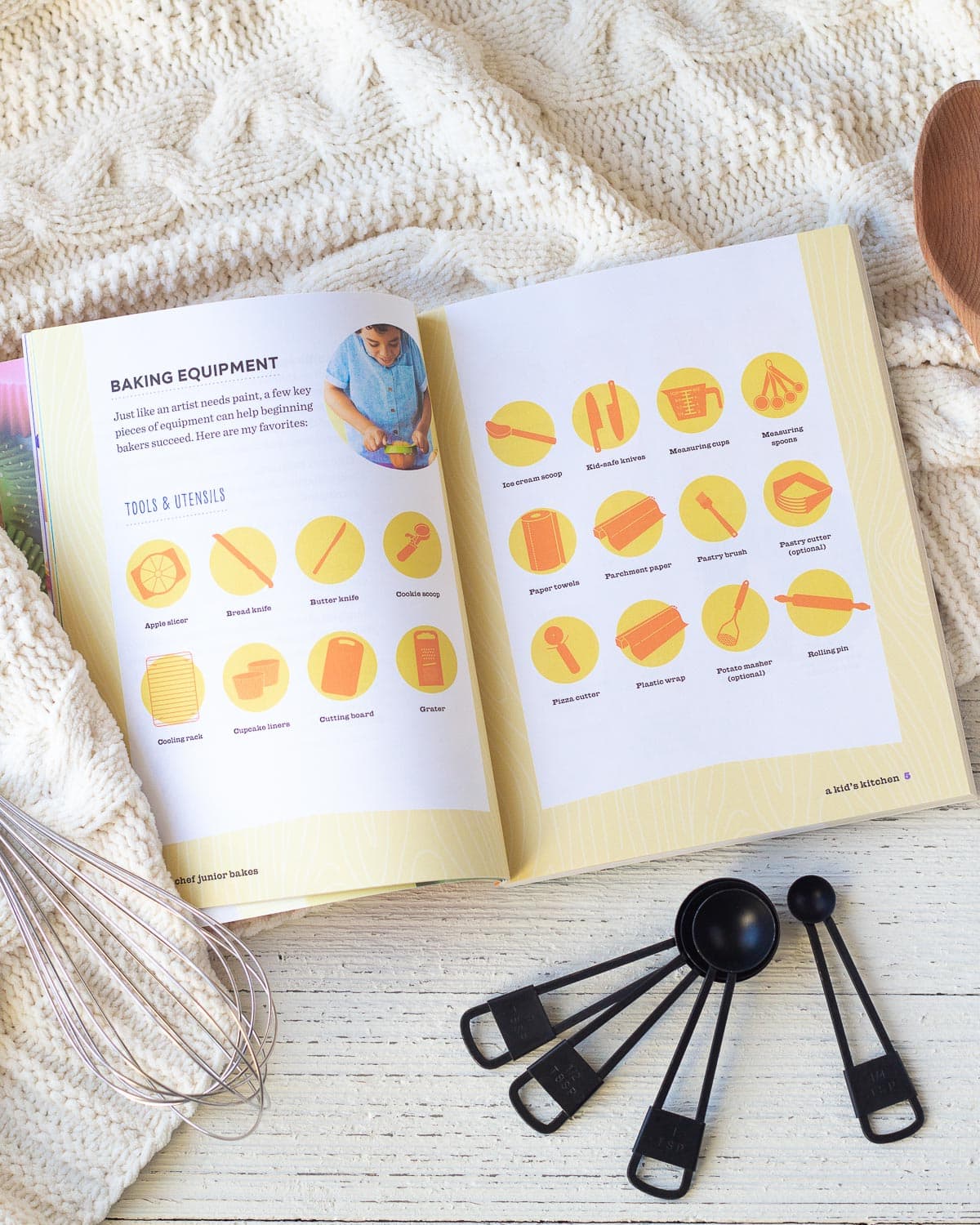 A baking book open on a wooden surface.