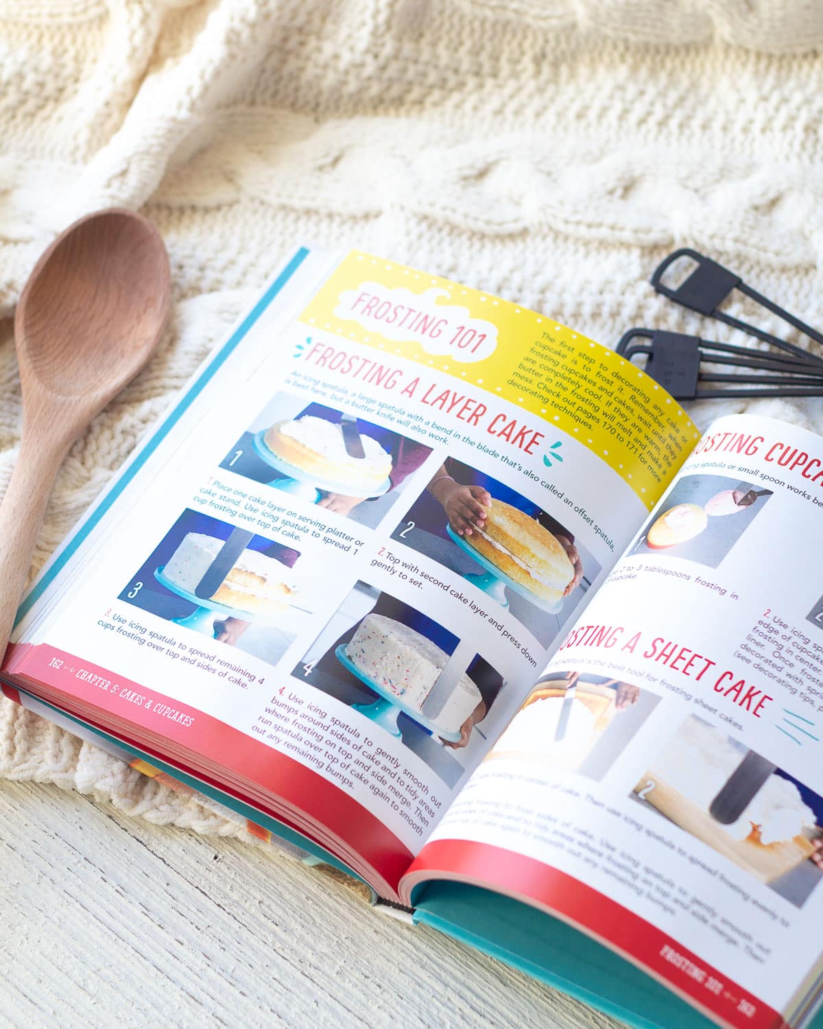 A baking book open to instructions about how to frost a cake.