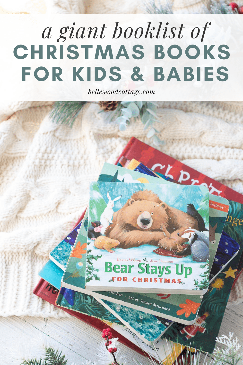 A stack of children's Christmas picture books on a cozy cream-colored blanket.