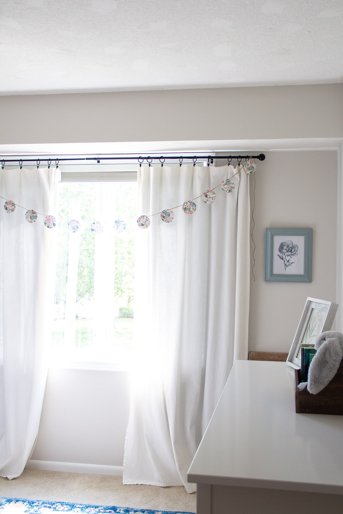 Bleached drop cloth curtains hanging in a nursery.