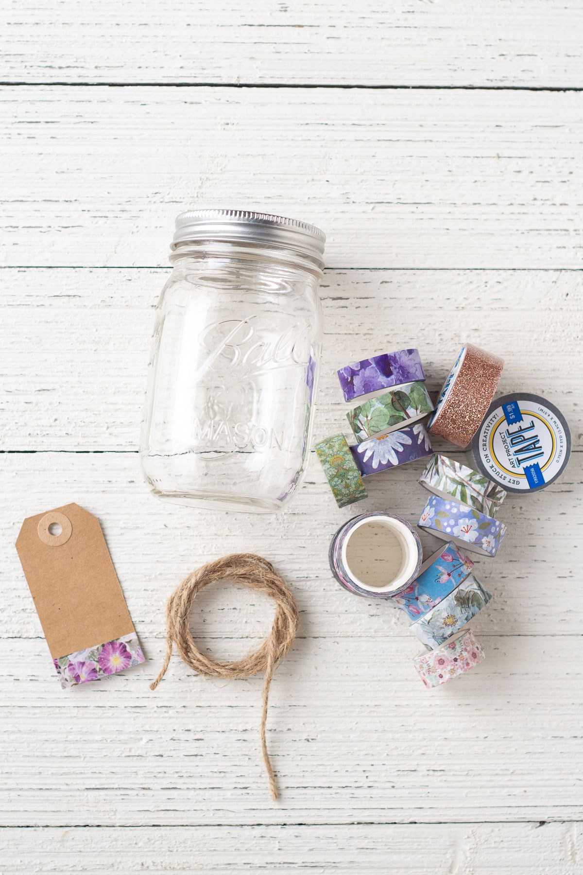 A mason jar, gift tag, twine, and washi tape.