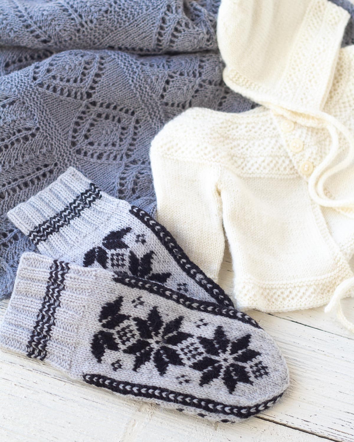 Selbuvotter mittens, a baby sweater, and a handknit lace blanket.