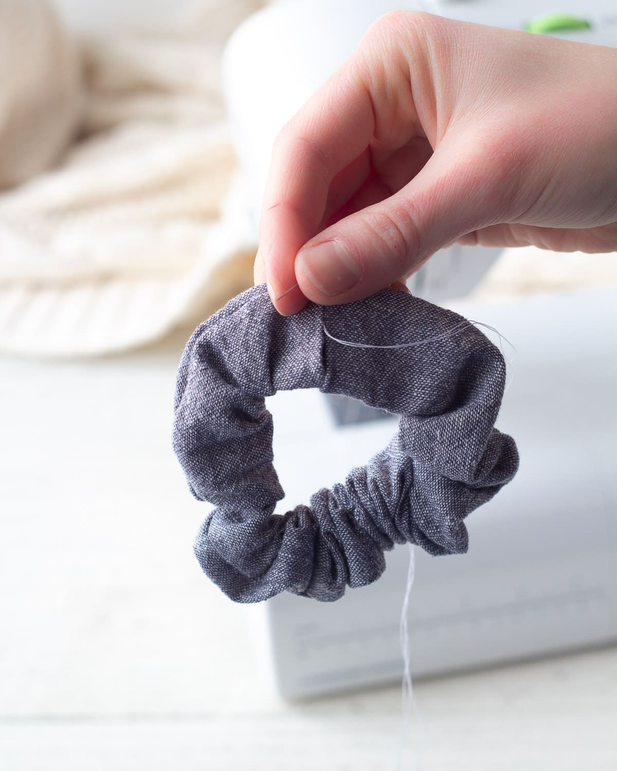 Using the ladder stitch to hand-sew a scrunchie closed.