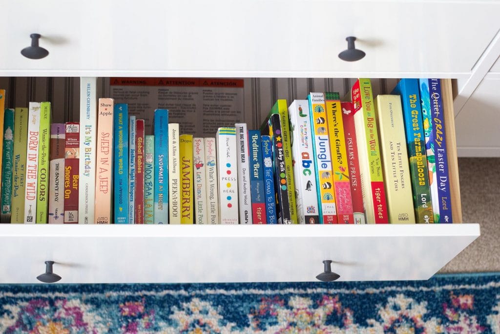 A display of baby board books stored in a drawer.