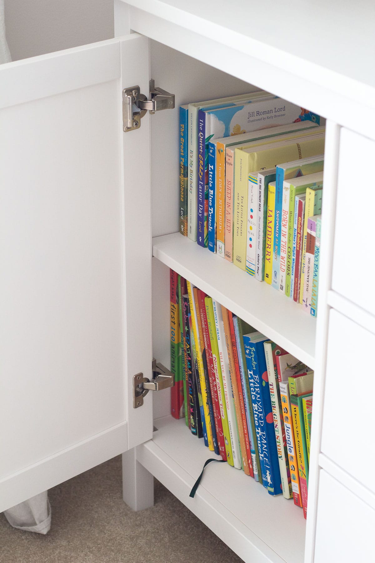 How to store kids books in a cupboard to hide them from view (board books and picture books).