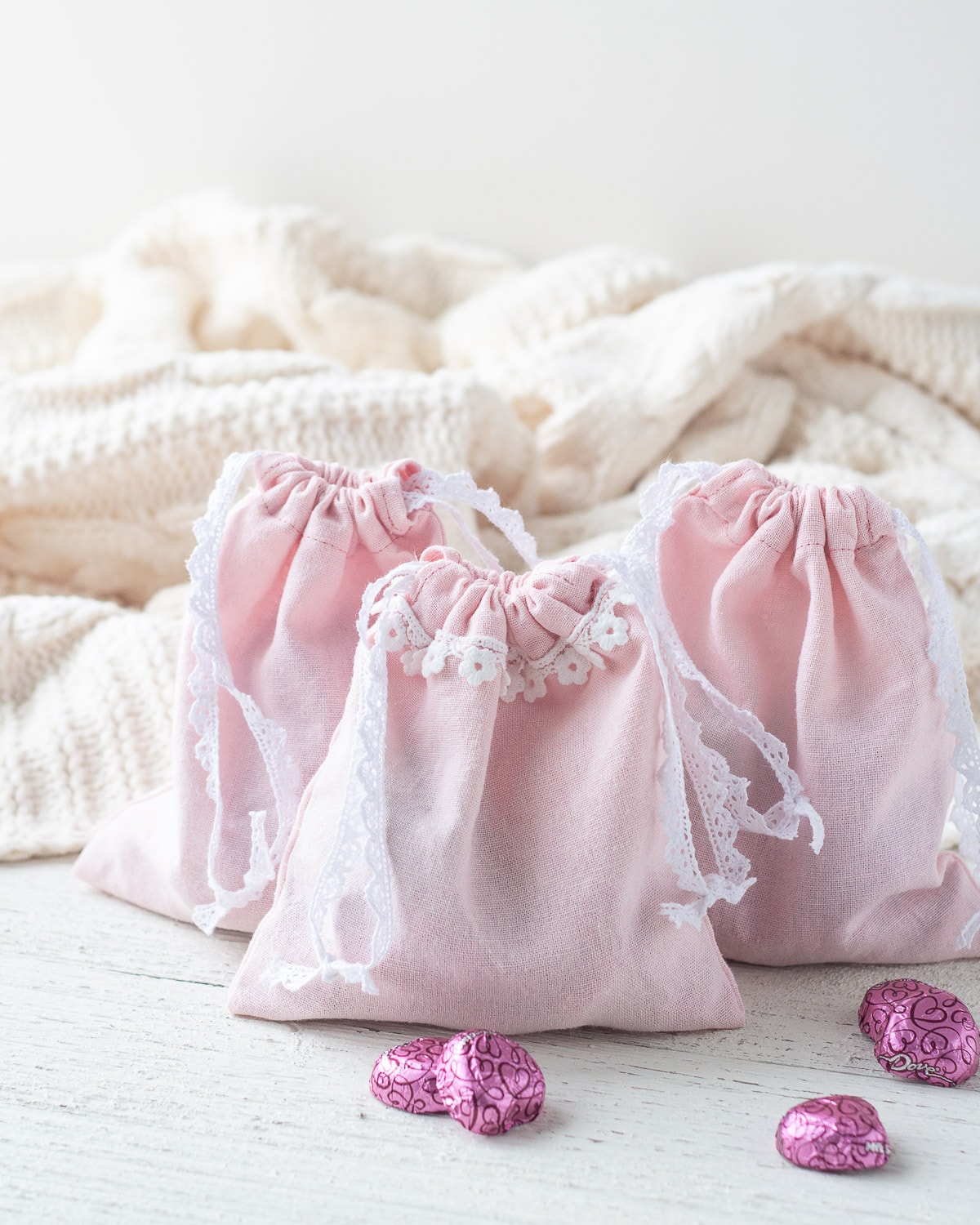 Valentine's Day DIY Gift Bags surrounded with heart-shaped chocolates.