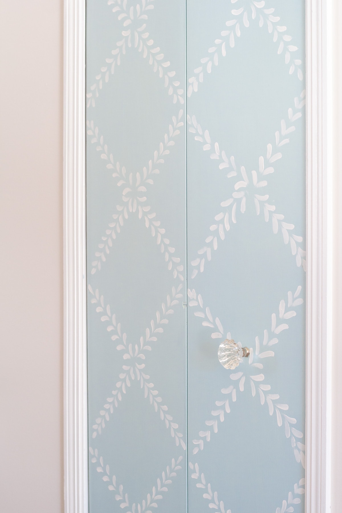 An old bi-fold pantry door updated with chalk paint in a floral design.