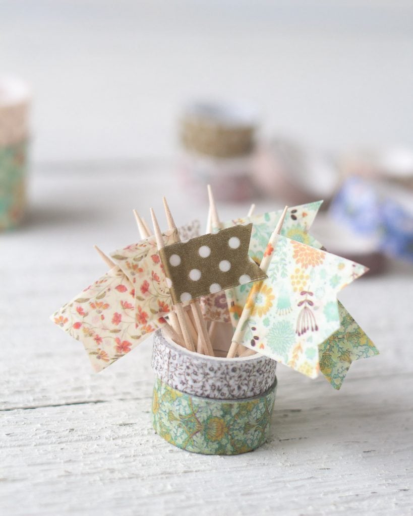 Mini flags created with washi tape and toothpicks.