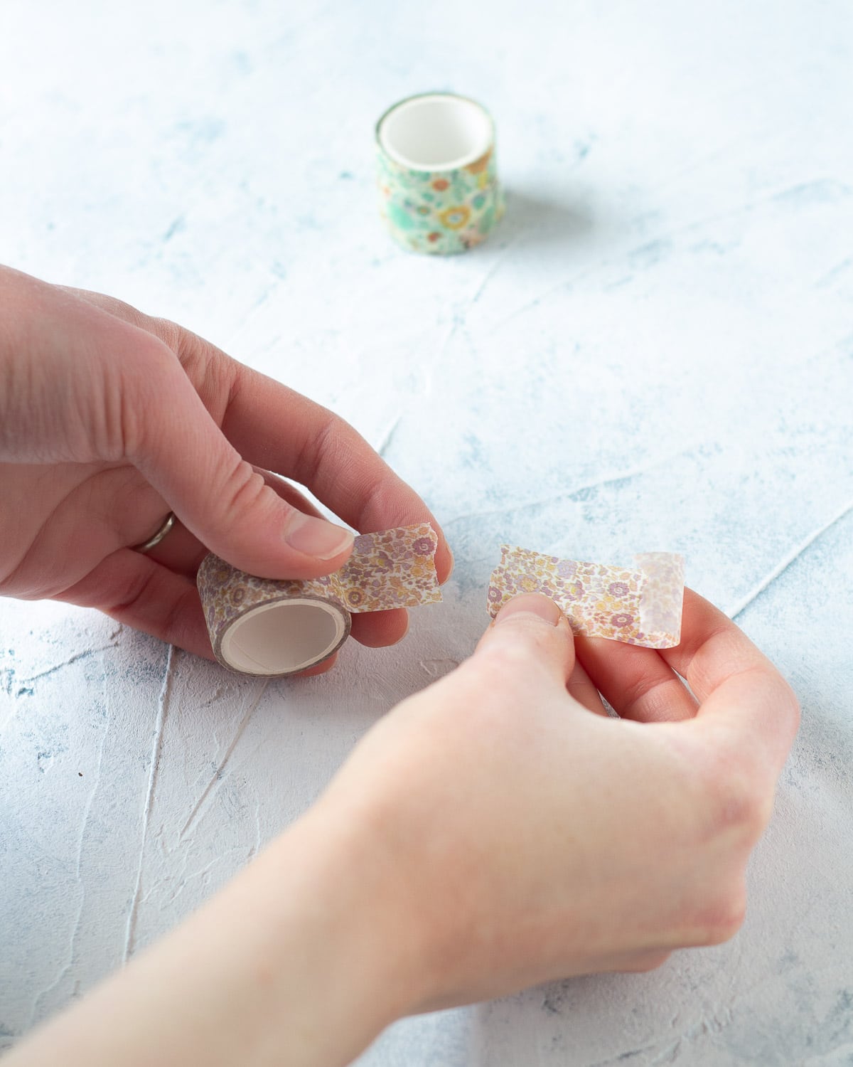 Tearing a piece of washi tape in half.