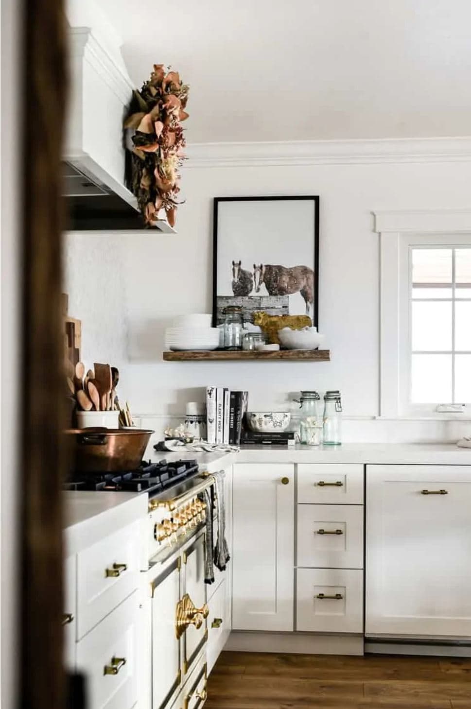 A farmhouse kitchen with a French range and white shaker cabinets.