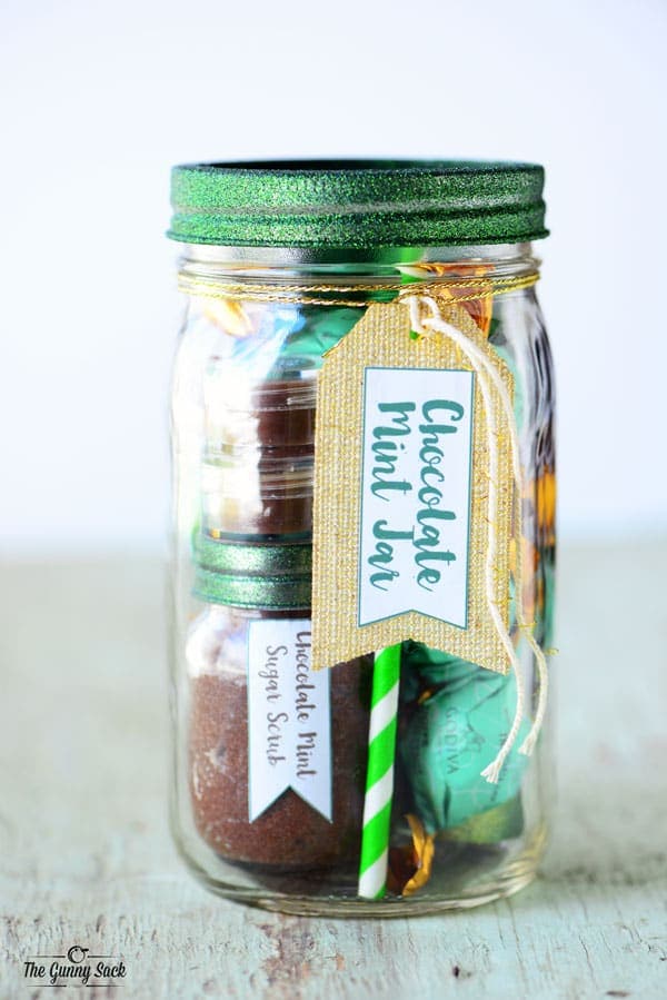 A mason jar filled with chocolate mint candy and spa items.