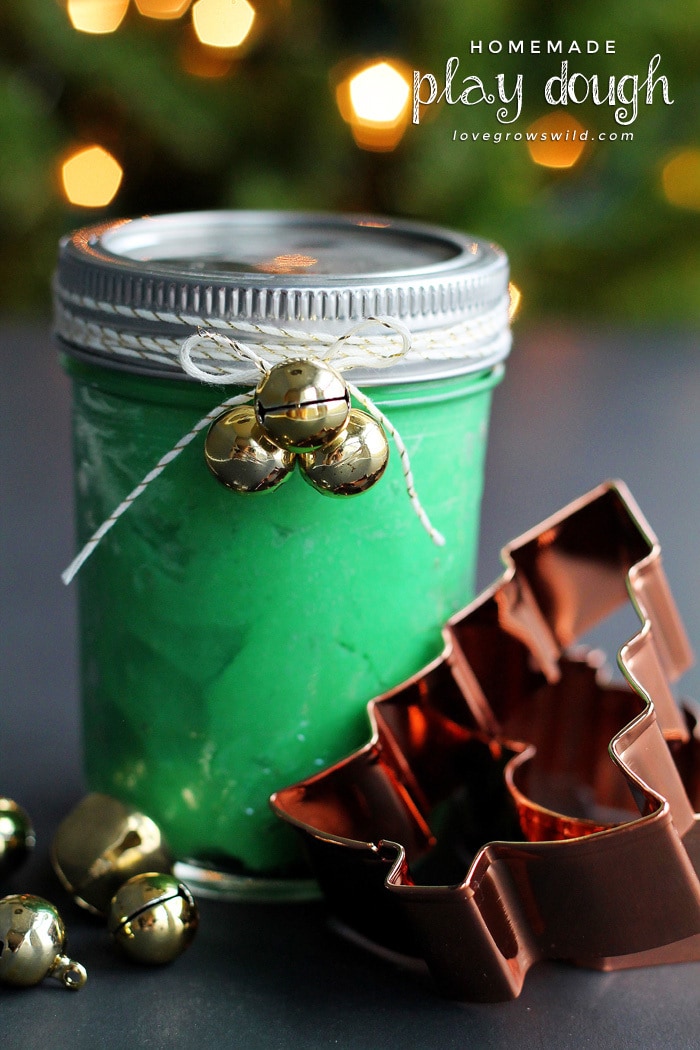 Green homemade playdough packed in a mason jar for a Christmas gift.