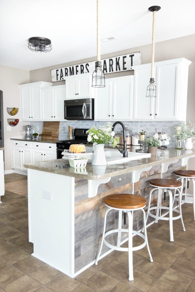 A builder grade kitchen updated to a farmhouse style kitchen with white cabinetry.