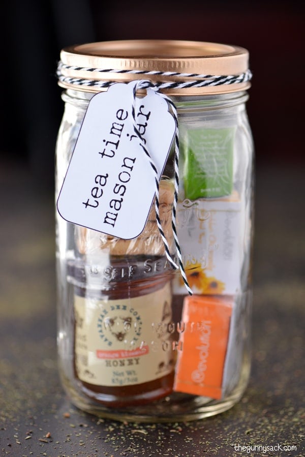 A "Tea Time" mason jar filled with miniature tea samples and a jar of honey.