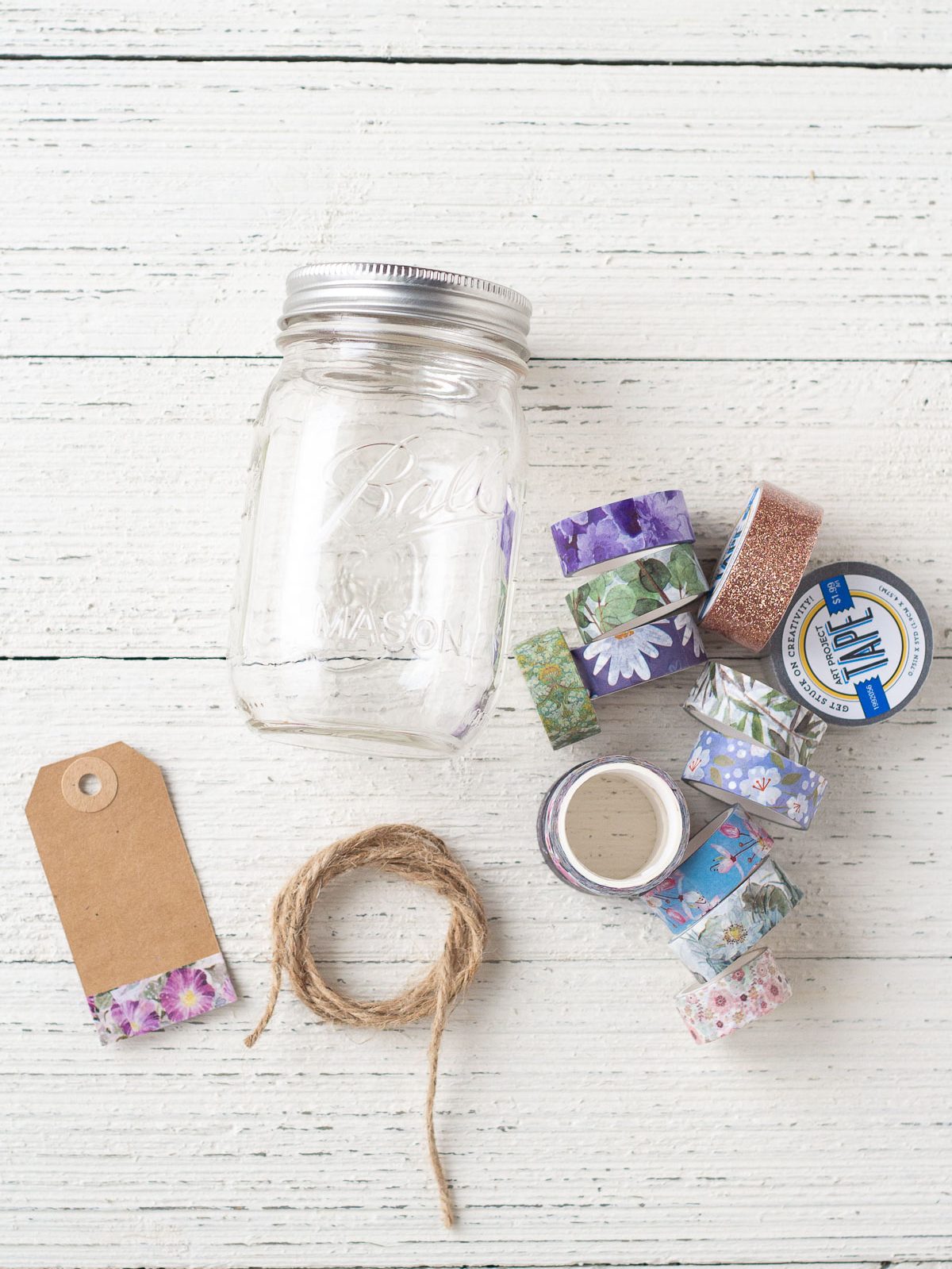 A mason jar, gift tag, twine, and washi tape.